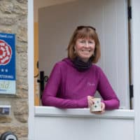 woman leaning on stable door